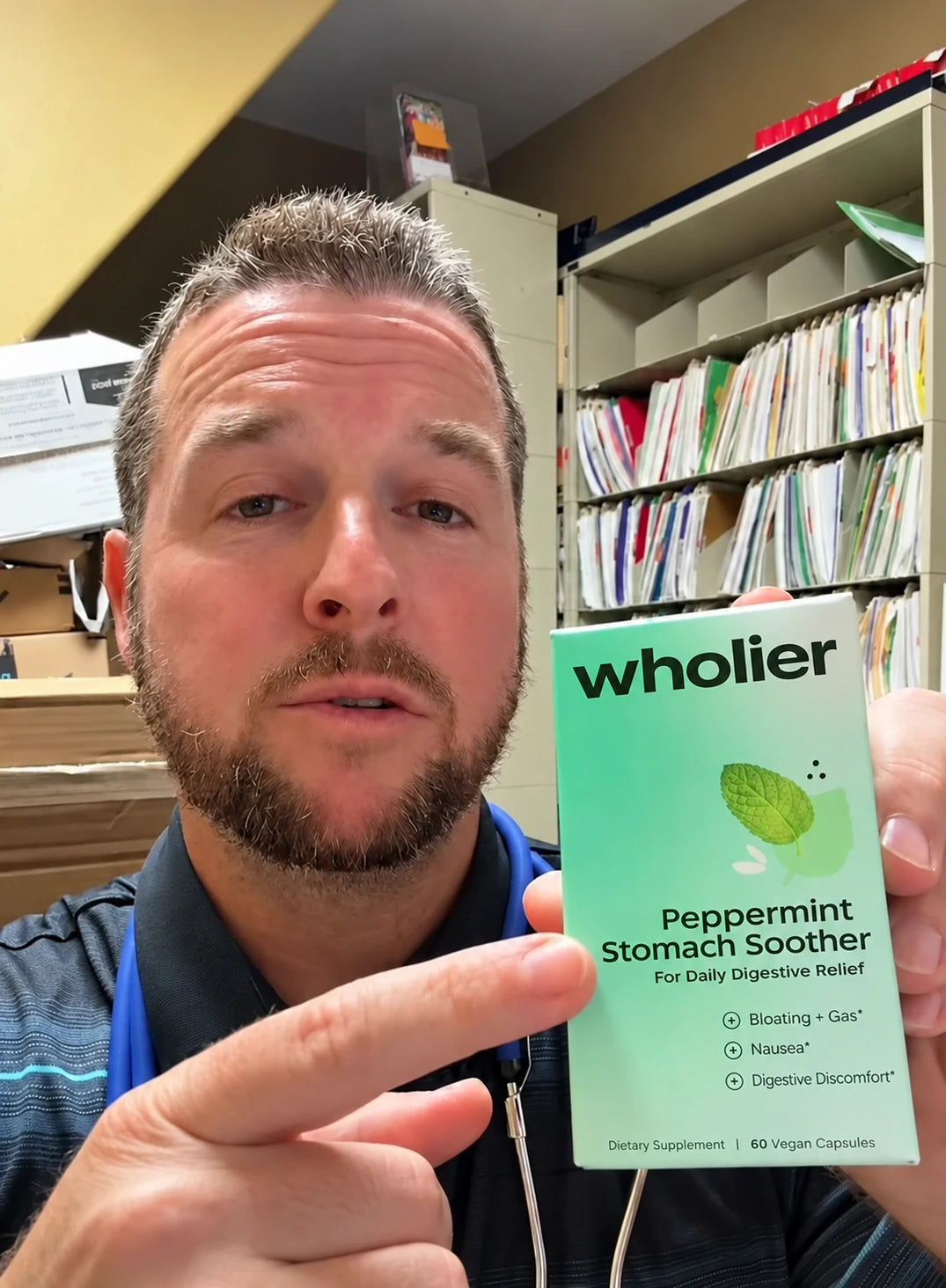 Doctor in his office pointing to a box of Peppermint Stomach Soother