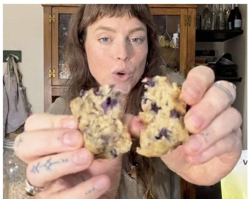 Holding fresh-baked blueberry protein muffins