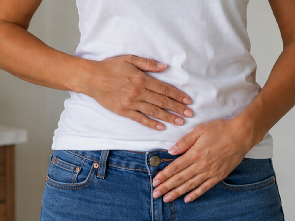 Woman resting her hands on a calm, unbloated stomach