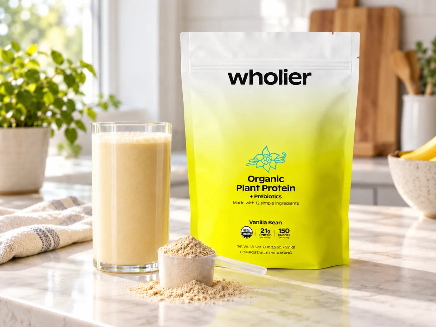 Vanilla Bean pouch with a scoop of powder and a glass of the blended shake on a kitchen counter
